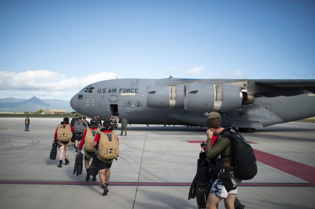 New York Air National Guardsmen prepare to board a C-17 Globemaster III during training to test new techniques and equipment that will be used to recover the crew module of NASA's Orion spacecraft in the waters off Joint Base Pearl Harbor-Hickam, Hawaii, March 7, 2017. Air National Guard photo by Staff Sgt. Christopher Muncy