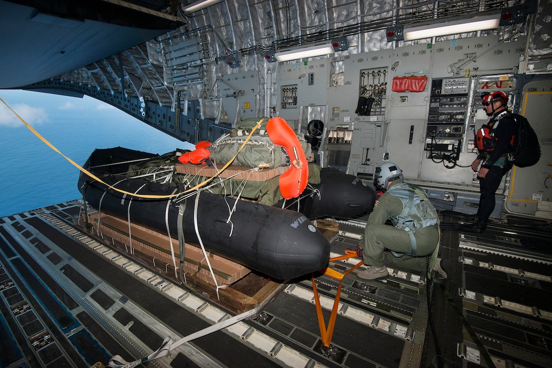 A Hawaii Air National Guardsman prepares to airdrop a preloaded inflatable boat from a C-17 Globemaster III into the waters near Joint Base Pearl Harbor-Hickam on March 7, 2017. The Hawaii Guardsmen were supporting New York Air National Guard pararescuemen and combat rescue officers as they trained to test new techniques and equipment that will be used to recover the crew module of NASA's Orion spacecraft. Air National Guard photo by Staff Sgt. Christopher Muncy