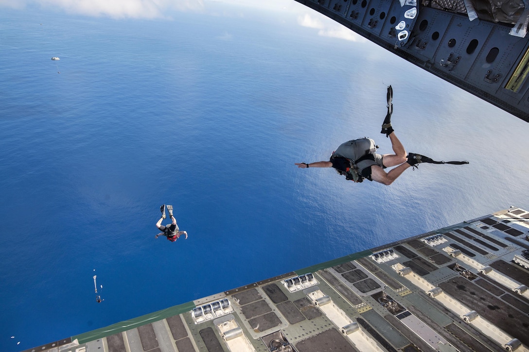 New York Air National Guardsmen jump from a C-17 Globemaster III into the waters off Joint Base Pearl Harbor-Hickam, Hawaii, March 7, 2017, as they train to test new techniques and equipment that will be used to recover the crew module of NASA's Orion spacecraft. Air National Guard photo by Staff Sgt. Christopher Muncy