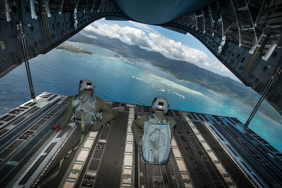 Hawaii Air National Guardsmen view the waters off Joint Base Pearl Harbor-Hickam, Hawaii, March 7, 2017, from the back ramp of a C-17  Globemaster III after completing training. Air National Guard photo by Staff Sgt. Christopher Muncy