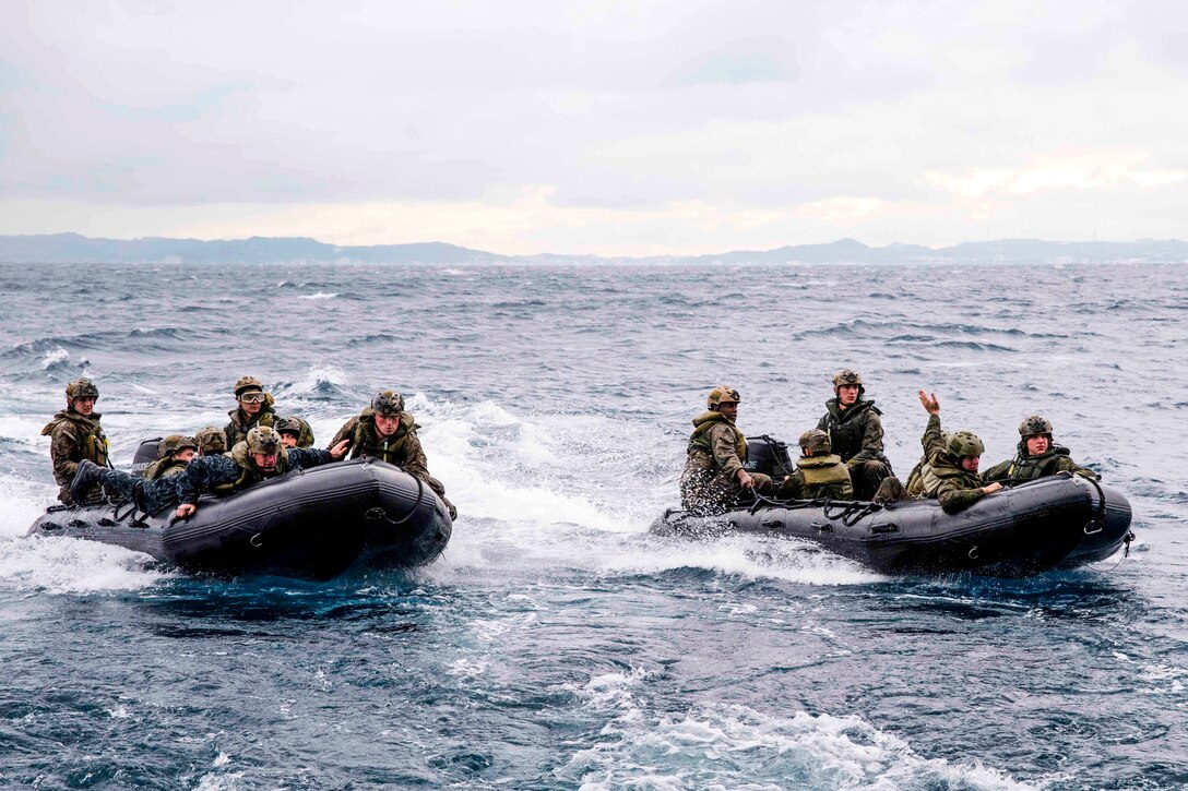 Navy Capt. Thomas Shultz, in blue on bow of left boat, and Marines prepare to land their watercraft on the well deck of the amphibious transport dock ship USS Green Bay during combat rubber raiding craft training in the Pacific Ocean, March 11, 2017. Shultz is the executive officer of the Green Bay. Navy photo by Petty Officer 1st Class Chris Williamson