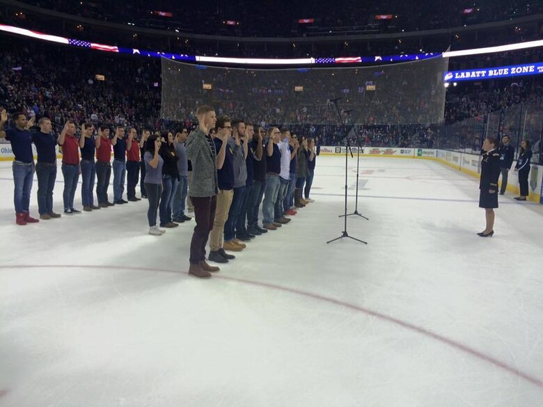 U.S. Marine Corps Poolees with Marine Corps Recruiting Sub-Stations North and South Columbus stand with others as they recite the Oath of Enlistment at the Columbus Blue Jackets game Jan. 21, 2017. The Oath of Enlistment pledge is made by each enlisted member of the Armed Forces. This is the final step before basic training and confirms their duty to defend the constitution and obey orders given by officers appointed over them.  (U.S. Marine Corps photo by Sgt. Caitlin Brink/Released)
