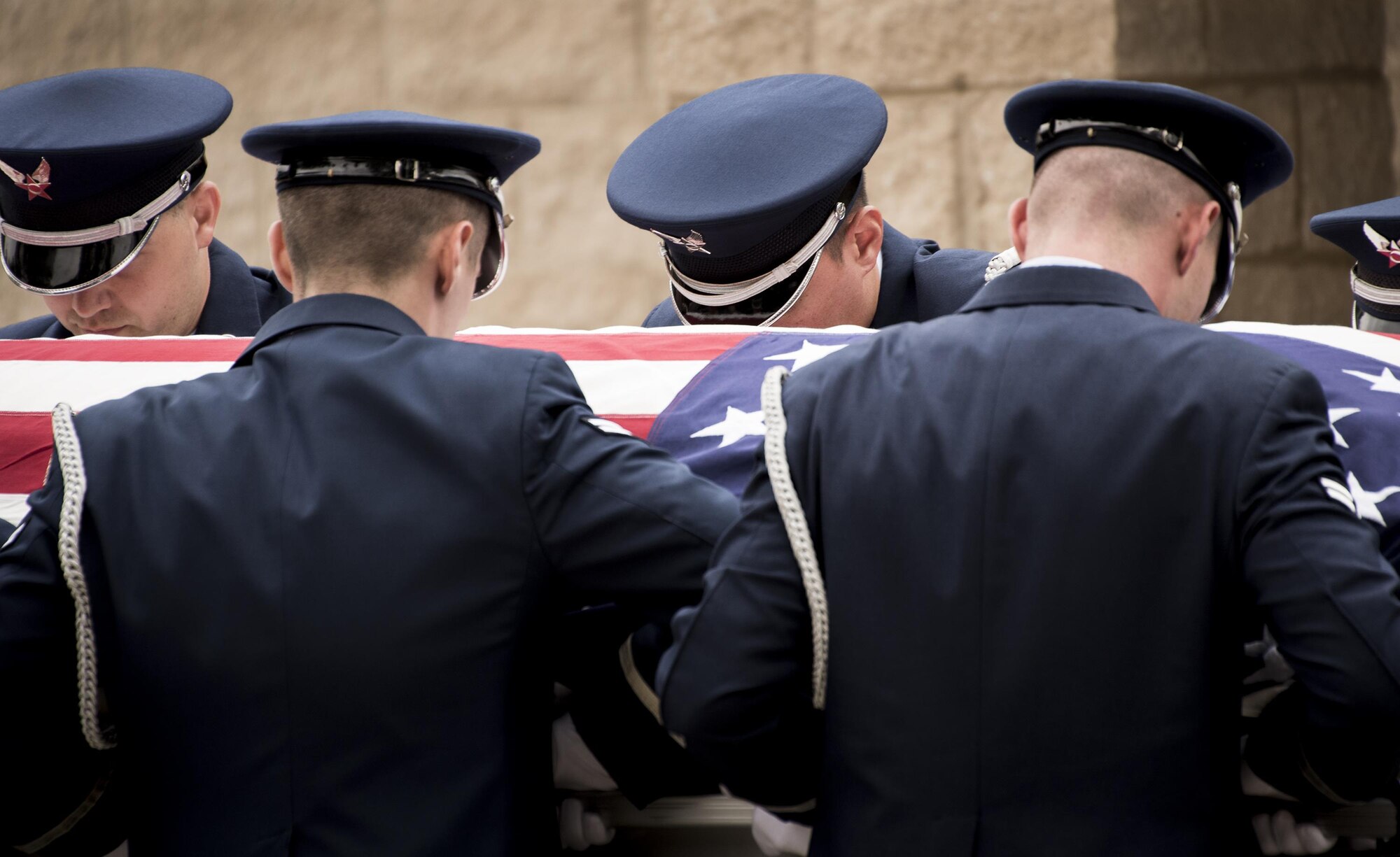 Honor Guard Airmen carry a casket out of a hearse during the unit’s graduation ceremony at Eglin Air Force Base, Fla., March 1.  Approximately 12 new Airmen graduated from the 120-plus-hour course. The graduation performance includes flag detail, rifle volley, pall bearers and bugler for friends, family and unit commanders. (U.S. Air Force photo/Samuel King Jr.)