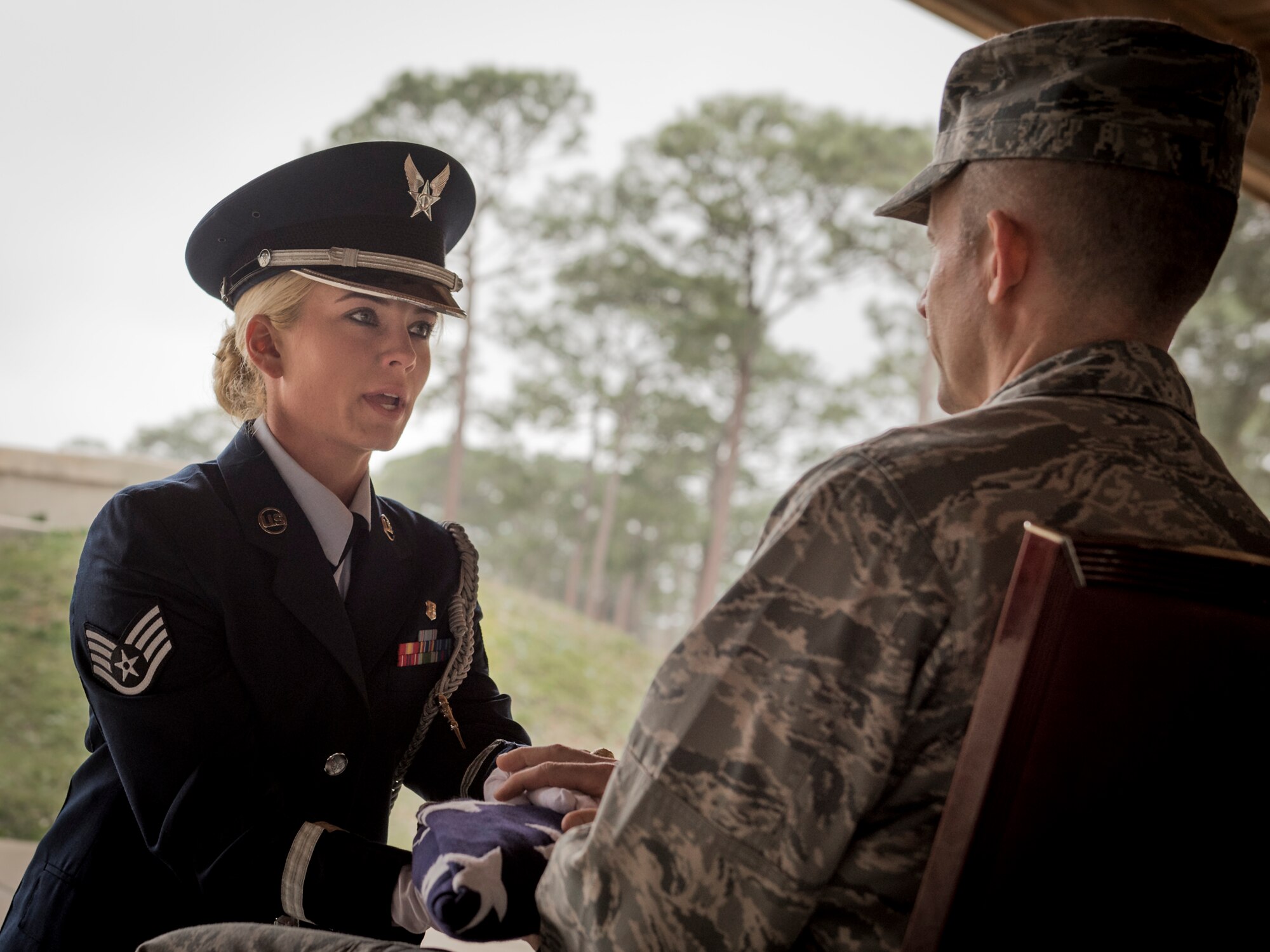 Staff Sgt. Elena Konter, 96th Medical Operations Squadron, presents a flag and recites the condolence message during the unit’s graduation ceremony at Eglin Air Force Base, Fla., March 1.  Approximately 12 new Airmen graduated from the 120-plus-hour course. The graduation performance includes flag detail, rifle volley, pall bearers and bugler for friends, family and unit commanders. (U.S. Air Force photo/Samuel King Jr.)