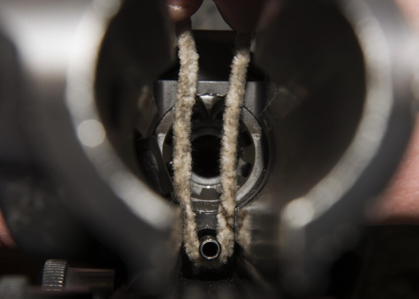 Airman 1st Class Cody Daganhart, 5th Security Forces Squadron staff armorer, cleans the inside of an M4 carbine top receiver at the armory on Minot Air Force Base, N.D., March 1, 2017. Weapons are cleaned at least once a month as well as three times after they have been fired at the range. (U.S. Air Force photo/Airman 1st Class Alyssa M. Akers)