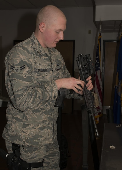 Airman 1st Class Cody Daganhart, 5th Security Forces Squadron staff armorer, checks his weapon at the armory on Minot Air Force Base, N.D., March 1, 2017. Security forces personnel check their weapons to ensure serviceability and readiness for training exercises. (U.S. Air Force photo/Airman 1st Class Alyssa M. Akers)