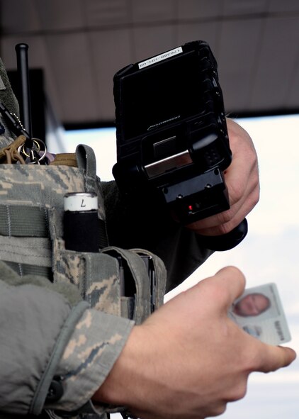 Airman 1st Class Hayden Wilson, a response force member assigned to the 28th Security Forces Squadron, scans a Common Access Card at the Liberty Gate, Ellsworth Air Force Base, S.D., March 9, 2017. The 28th SFS has upgraded their previous Defense Biometric Identification System, increasing the processing speed for information from the DBIDS database. (U.S. Air Force photo by Airman Nicolas Z. Erwin)