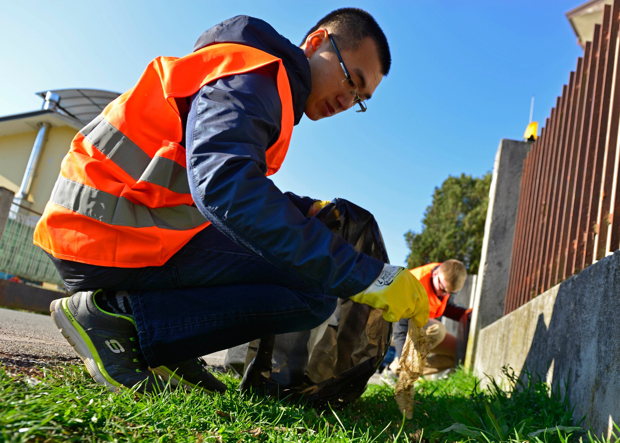 Airman 1st Class Shan Dun Zhang, 724th Air Mobility Squadron passenger service agent, picks up trash during a city cleanup event in Aviano, March 12, 2017. Volunteers from Aviano Air Base joined local Italians to walk the city streets and pick up trash. (U.S. Air Force photo by Senior Airman Cary Smith)
