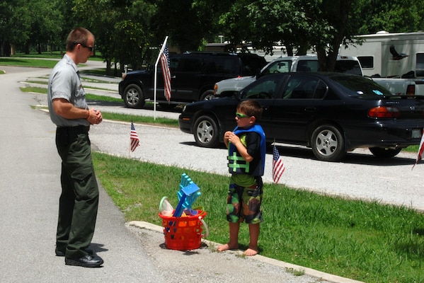 Park Ranger Phillip Sliger greets a kid wearing a life jacket at Defeated Creek Campground during a past recreation season. The campground at Cordell Hull Lake is one of 25 campgrounds at eight lakes the U.S. Army Corps of Engineers Nashville District operates every recreation season. The public is encouraged to begin reserving for the 2017 recreation season at www.recreation.gov. 