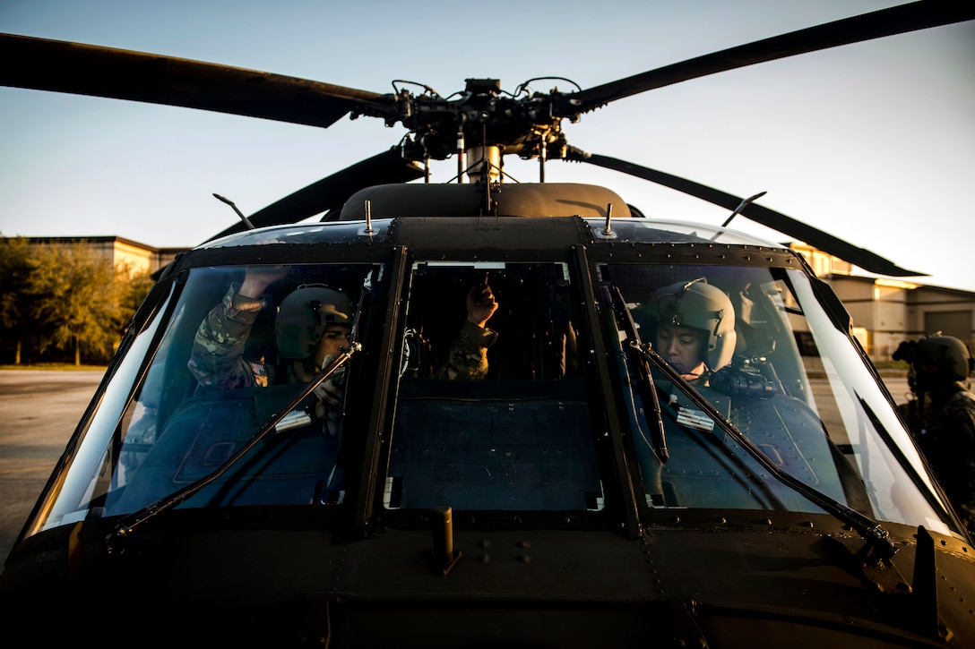 Army pilots conduct pre-flight checks inside the cockpit of a UH-60 Black Hawk helicopter before taking off during Emerald Warrior 17 at Hurlburt Field, Fla., March 6, 2017. The pilots are assigned to the 2nd Battalion, 135th Aviation Regiment. Air Force photo by Staff Sgt. Corey Hook