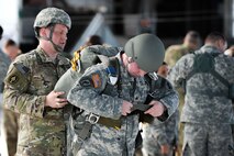 U.S. Army Reserve Capt. Camm Garrett, 412th Civil Affairs Battalion civil military operations cell chief, helps Sgt. Adam Swinehart, 412th CA sergeant, adjust his parachute in preparation for a jump at Wright-Patterson Air Force Base, Ohio, March 11, 2017. The 412th Civil Affairs Battalion (Airborne) mobilizes, deploys, plans and conducts civil affairs operations with an orientation to the theater commander. (U.S. Air Force photo by Wesley Farnsworth / Released)
