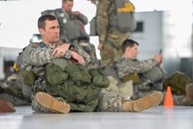 U.S. Army Reserve Maj. Phil Gryskewicz, 412th Civil Affairs Battalion higher headquarters company commander, relaxes after putting on all his gear prior to conducting a jump at Wright-Patterson Air Force Base, Ohio, as part of a joint service training exercise, March 11, 2017. Members of the 88th Operations Support Squadron, 88th Security Forces Squadron, 788th Civil Engineer Squadron, and 88th Medical Operations Squadron provided support to the paratroop operations. (U.S. Air Force photo by Wesley Farnsworth / Released)