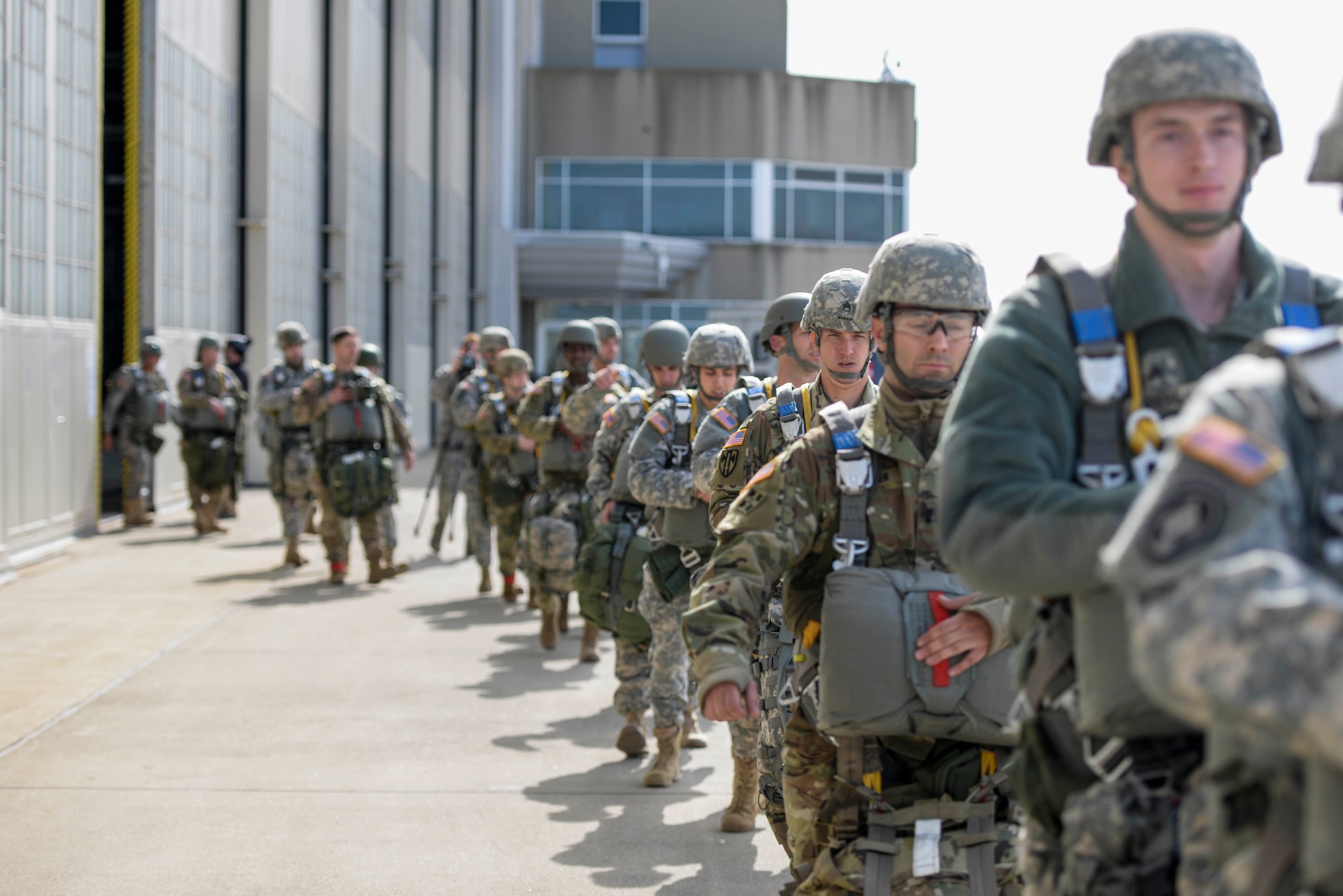 Soldiers with the 412th Civil Affairs Battalion and 346th Psychological Operations Company, based in Whitehall, Ohio, walk out to waiting C-130 aircraft, which will take them over Wright-Patterson Air Force Base, Ohio, to conduct a jump as part of a joint service training exercise, March 11, 2017. The 412th Civil Affairs Battalion (Airborne) mobilizes, deploys, plans and conducts civil affairs operations with an orientation to the theater commander. (U.S. Air Force photo by Wesley Farnsworth / Released)