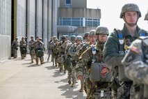 Soldiers with the 412th Civil Affairs Battalion and 346th Psychological Operations Company, based in Whitehall, Ohio, walk out to waiting C-130 aircraft, which will take them over Wright-Patterson Air Force Base, Ohio, to conduct a jump as part of a joint service training exercise, March 11, 2017. The 412th Civil Affairs Battalion (Airborne) mobilizes, deploys, plans and conducts civil affairs operations with an orientation to the theater commander. (U.S. Air Force photo by Wesley Farnsworth / Released)