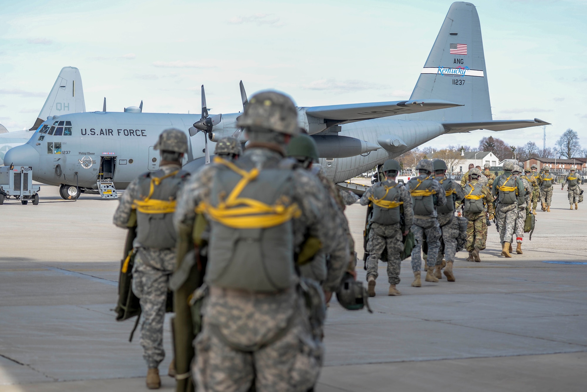 Soldiers with the 412th Civil Affairs Battalion and 346th Psychological Operations Company, based in Whitehall, Ohio, walk out to an H model C-130 aircraft from the Air National Guard’s 123rd Airlift Wing in Louisville, Kentucky, at Wright-Patterson Air Force Base, Ohio, March 11, 2017. The soldiers were conducting the jump as part of a joint service training exercise. (U.S. Air Force photo by Wesley Farnsworth / Released)