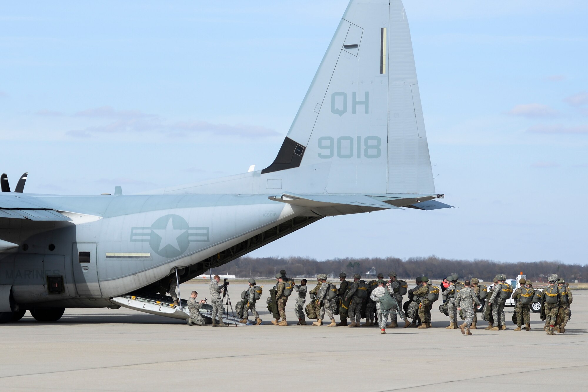 Soldiers with the 412th Civil Affairs Battalion and 346th Psychological Operations Company, based in Whitehall, Ohio, walk out to a J model C-130 aircraft from Marine Corp’s 252 Marine Aerial Refueler Transport Squadron, Marine Aircraft Group 14, 2nd Marine Aerial Wing, Marine Corps Air Station, North Carolina, at Wright-Patterson Air Force Base, Ohio, March 11, 2017. The soldiers were conducting the jump as part of a joint service training exercise. (U.S. Air Force photo by Wesley Farnsworth / Released)