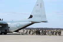 Soldiers with the 412th Civil Affairs Battalion and 346th Psychological Operations Company, based in Whitehall, Ohio, walk out to a J model C-130 aircraft from Marine Corp’s 252 Marine Aerial Refueler Transport Squadron, Marine Aircraft Group 14, 2nd Marine Aerial Wing, Marine Corps Air Station, North Carolina, at Wright-Patterson Air Force Base, Ohio, March 11, 2017. The soldiers were conducting the jump as part of a joint service training exercise. (U.S. Air Force photo by Wesley Farnsworth / Released)