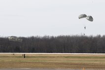 Soldiers with the 412th Civil Affairs Battalion and 346th Psychological Operations Company, based in Whitehall, Ohio, descend to a drop zone established on the flightline of Wright-Patterson Air Force Base, Ohio, March 11, 2017. The soldiers were participating in a joint service training exercise including both day and night jump operations  (U.S. Air Force photo by Wesley Farnsworth / Released)