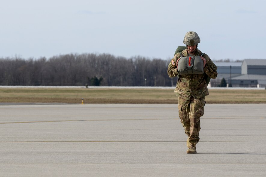 U.S. Army Reserve Capt. Michael Huber walks back to the hangar at Wright-Patterson Air Force Base, Ohio, after a successful jump as part of a joint service training exercise, March 11, 2017. Members of the 88th Operations Support Squadron, 88th Security Forces Squadron, 788th Civil Engineer Squadron, and 88th Medical Operations Squadron provided support to the paratroop operations. (U.S. Air Force photo by Wesley Farnsworth / Released)