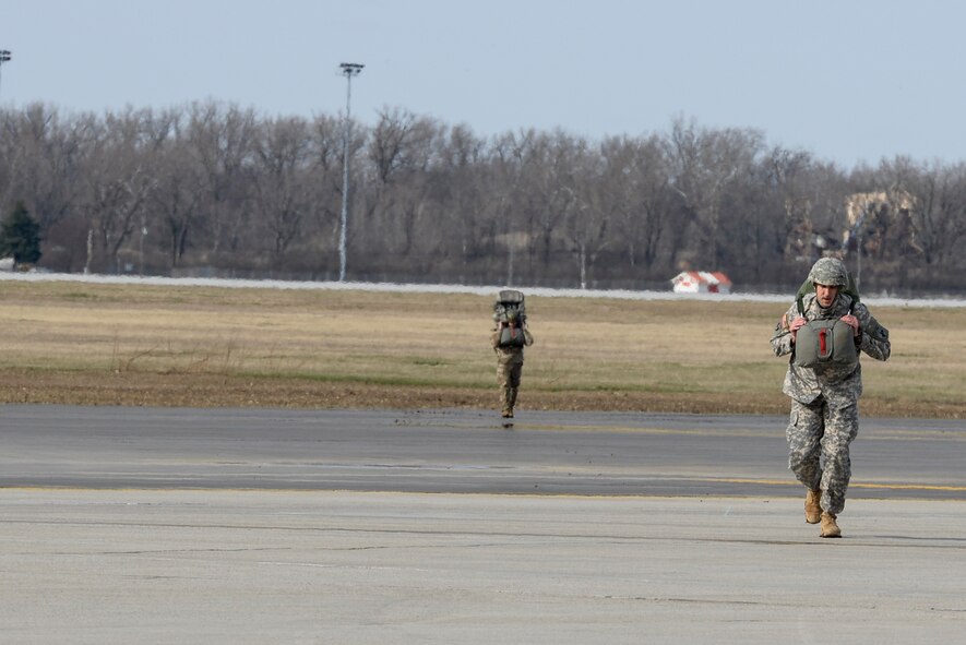 Soldiers with the 412th Civil Affairs Battalion and 346th Psychological Operations Company, based in Whitehall, Ohio, return from the drop zone after a successful paratroop jump at Wright-Patterson Air Force Base, Ohio, March 11, 2017. Members of the 88th Operations Support Squadron, 88th Security Forces Squadron, 788th Civil Engineer Squadron, and 88th Medical Operations Squadron provided support to the paratroop operations. (U.S. Air Force photo by Wesley Farnsworth / Released)