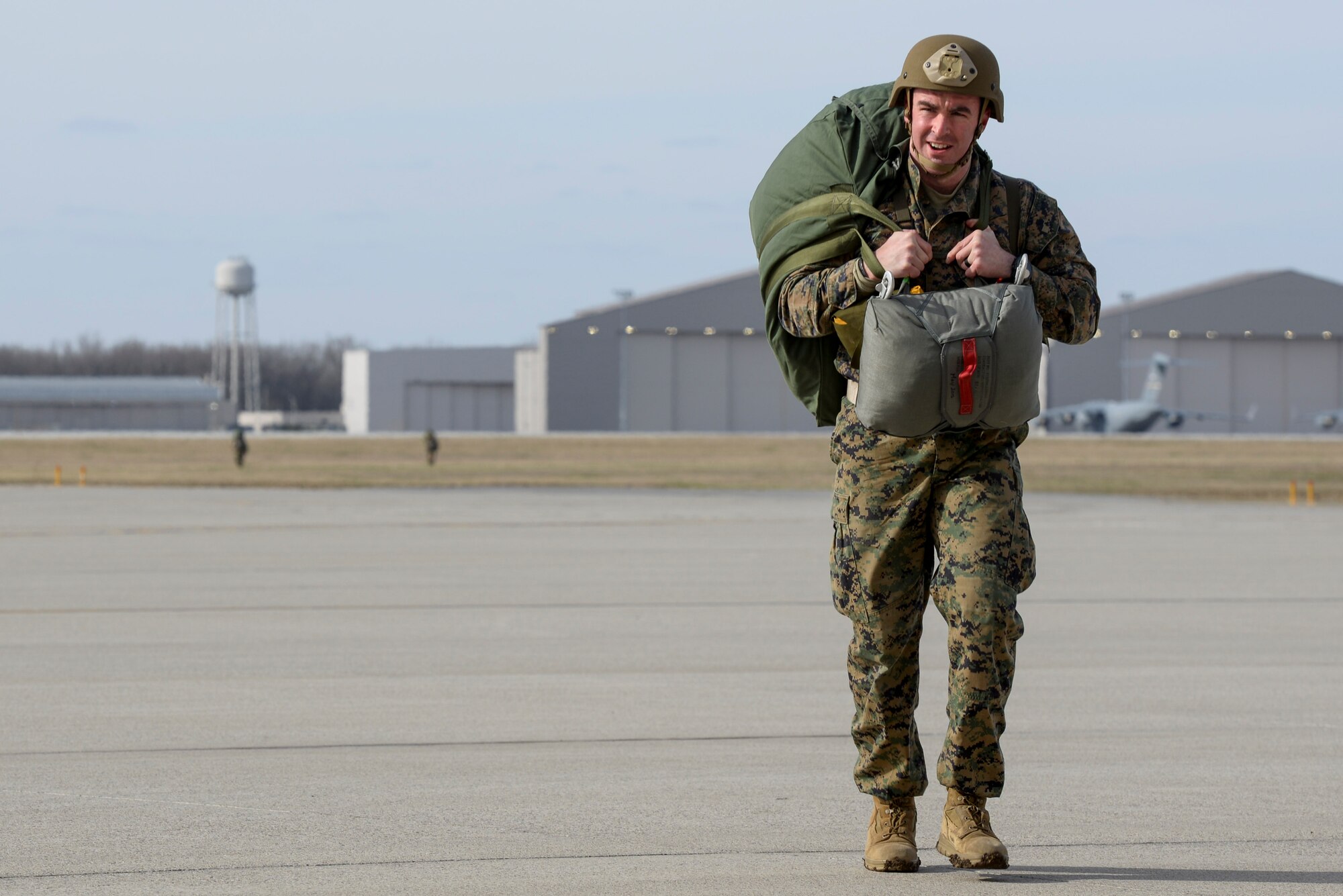 Marine Capt. Richard Spicer, a firepower control team leader with the 4th Air Naval Gunfire Liaison Company, West Palm Beach, Fla., returns from the drop zone after a successful jump at Wright-Patterson Air Force Base, Ohio, March 11, 2017. Members of the 88th Operations Support Squadron, 88th Security Forces Squadron, 788th Civil Engineer Squadron, and 88th Medical Operations Squadron provided support to the paratroop operations. (U.S. Air Force photo by Wesley Farnsworth / Released)