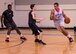 Adam Brakeville, 53rd Wing, dribbles the ball around Bryan Wilson, Armament Directorate, during the intramural basketball championship March 6 at Eglin Air Force Base Fla. The EB team defeated the 53rd Wing team 53-42 to take the trophy. (U.S. Air Force photo/Ilka Cole)