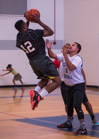 Stephan Atrice, Armament Directorate, jumps to make a basket during the intramural basketball championship March 6 at Eglin Air Force Base Fla. The EB team defeated the 53rd Wing team 53-42 to take the trophy. (U.S. Air Force photo/Ilka Cole) 