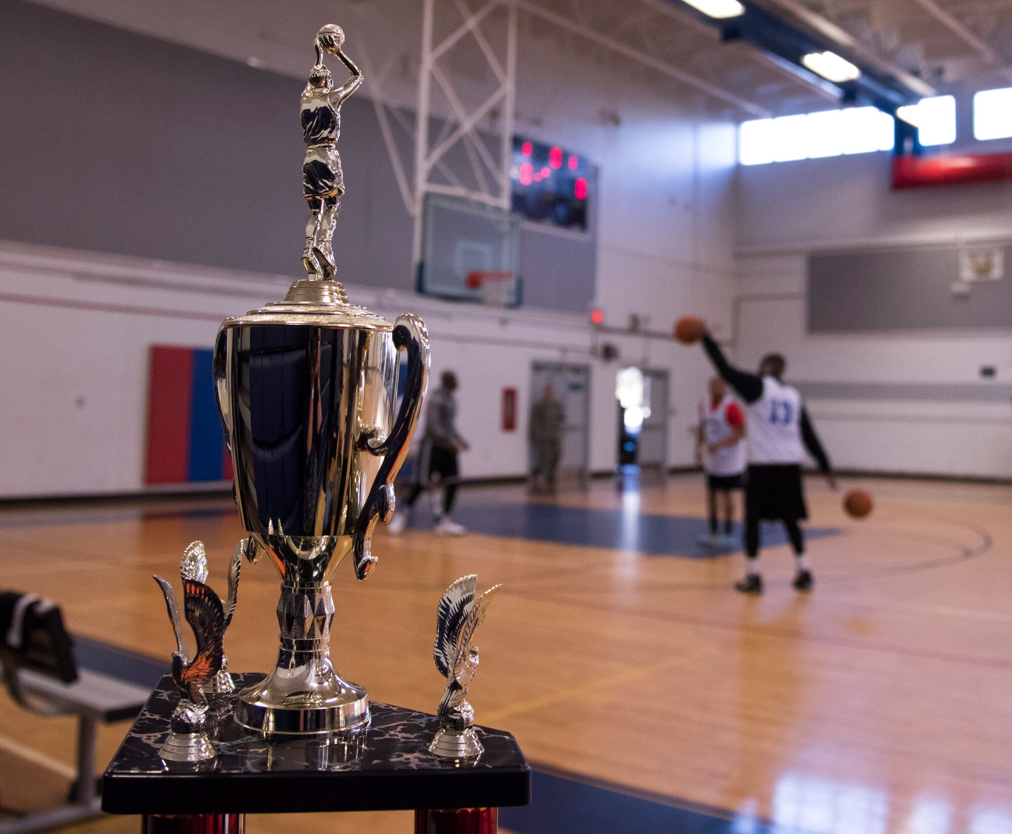 The trophy for the intramural basketball championship sits courtside during the warm-up period before the game March 6 at Eglin Air Force Base Fla. The Armament Directorate team defeated the 53rd Wing team 53-42 to take the trophy. (U.S. Air Force photo/Ilka Cole) 