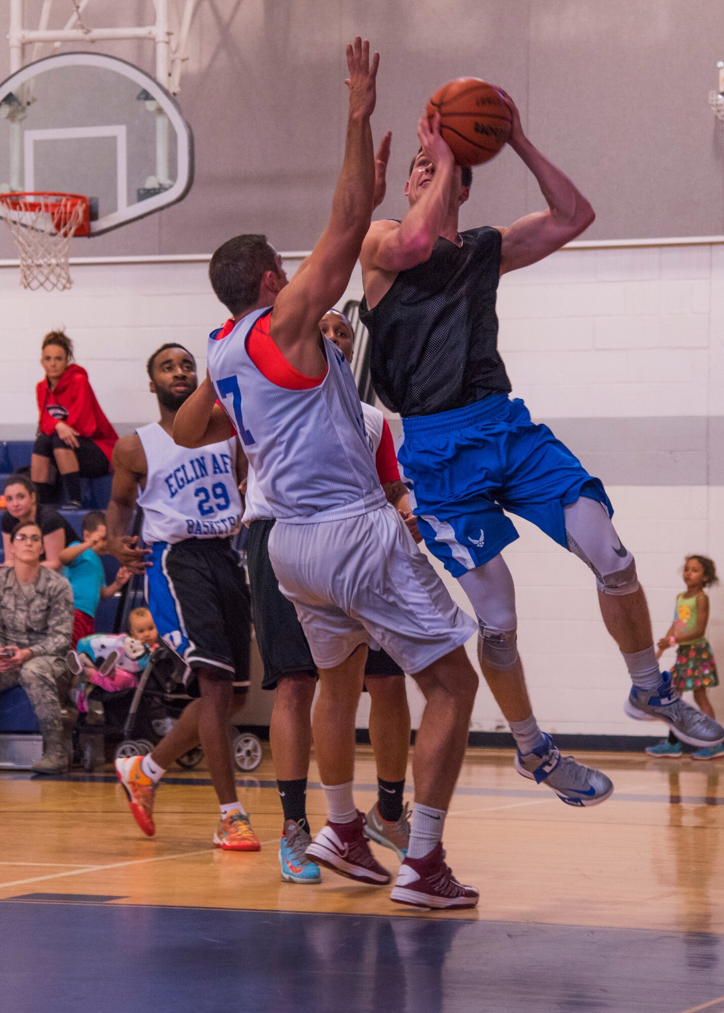 David Adler, Armament Directorate, takes a shot while Adam Brakeville, 53rd Wing, goes in for a block during the intramural basketball championship March 6 at Eglin Air Force Base Fla. The EB team defeated the 53rd Wing team 53-42 to take the trophy. (U.S. Air Force photo/Ilka Cole) 