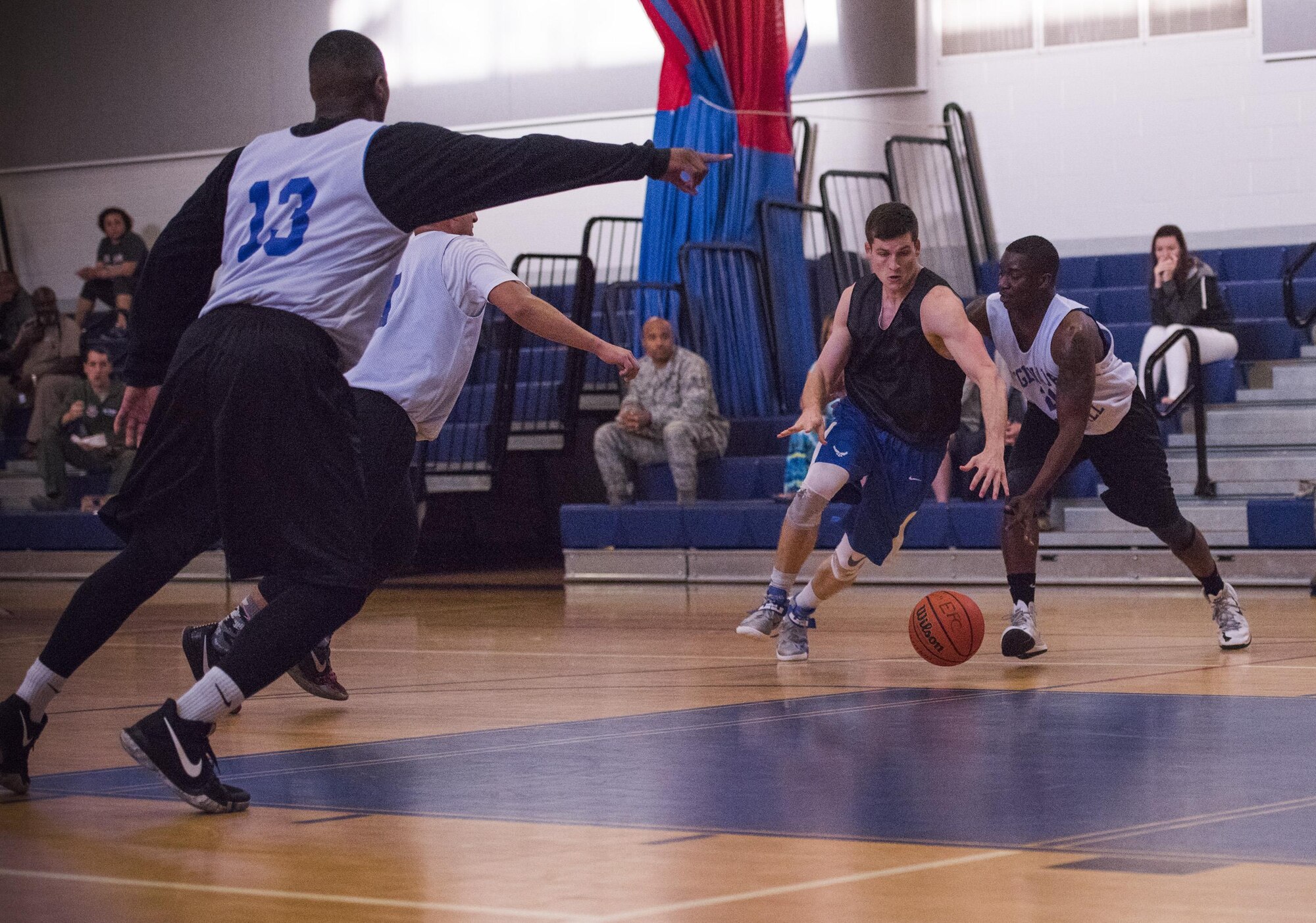 David Adler, Armament Directorate and a 53rd Wing competitor, race toward the ball during the intramural basketball championship March 6 at Eglin Air Force Base Fla. The EB team defeated the 53rd Wing team 53-42 to take the trophy. (U.S. Air Force photo/Ilka Cole) 