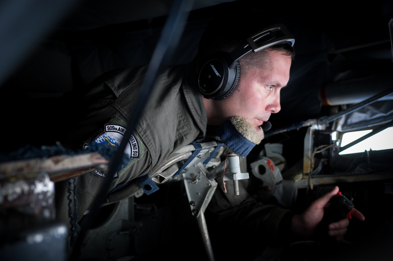 U.S. Air Force Senior Master Sgt. Douglas Palmisano, 909th Air Refueling Squadron boom operator and superintendent, conducts an inflight refuel March 6, 2017, en route to Kadena Air Base, Japan. Boom operators on a KC-135 have the ability to pump thousands of pounds of fuel to any capable aircraft, thousands of feet above the ground, flying at 230 miles per hour, while only 47 feet from the receiving aircraft. (U.S. Air Force photo by Senior Airman John Linzmeier)