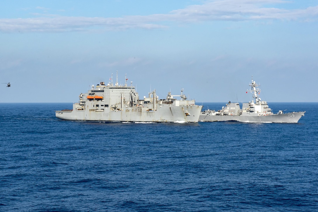 The Military Sealift Command dry-cargo and ammunition ship USNS Richard E. Byrd, left, prepares to conduct a dual replenishment at sea with the guided missile destroyer USS Wayne E. Meyer and the aircraft carrier USS Carl Vinson, not pictured, in the South China Sea, March 5, 2017. Navy photo by Petty Officer 2nd Class Sean M. Castellan