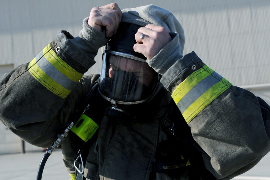 Tim McCartney North Lemmon fire department firefighter, takes off his mask at Minot Air Force Base, N.D., Feb. 24, 2017 The Minot AFB fire department hosted training with local fire departments, scenarios included simulated helicopter fire and missile field response. (U.S. Air Force photo/Staff Sgt. Chad Trujillo)