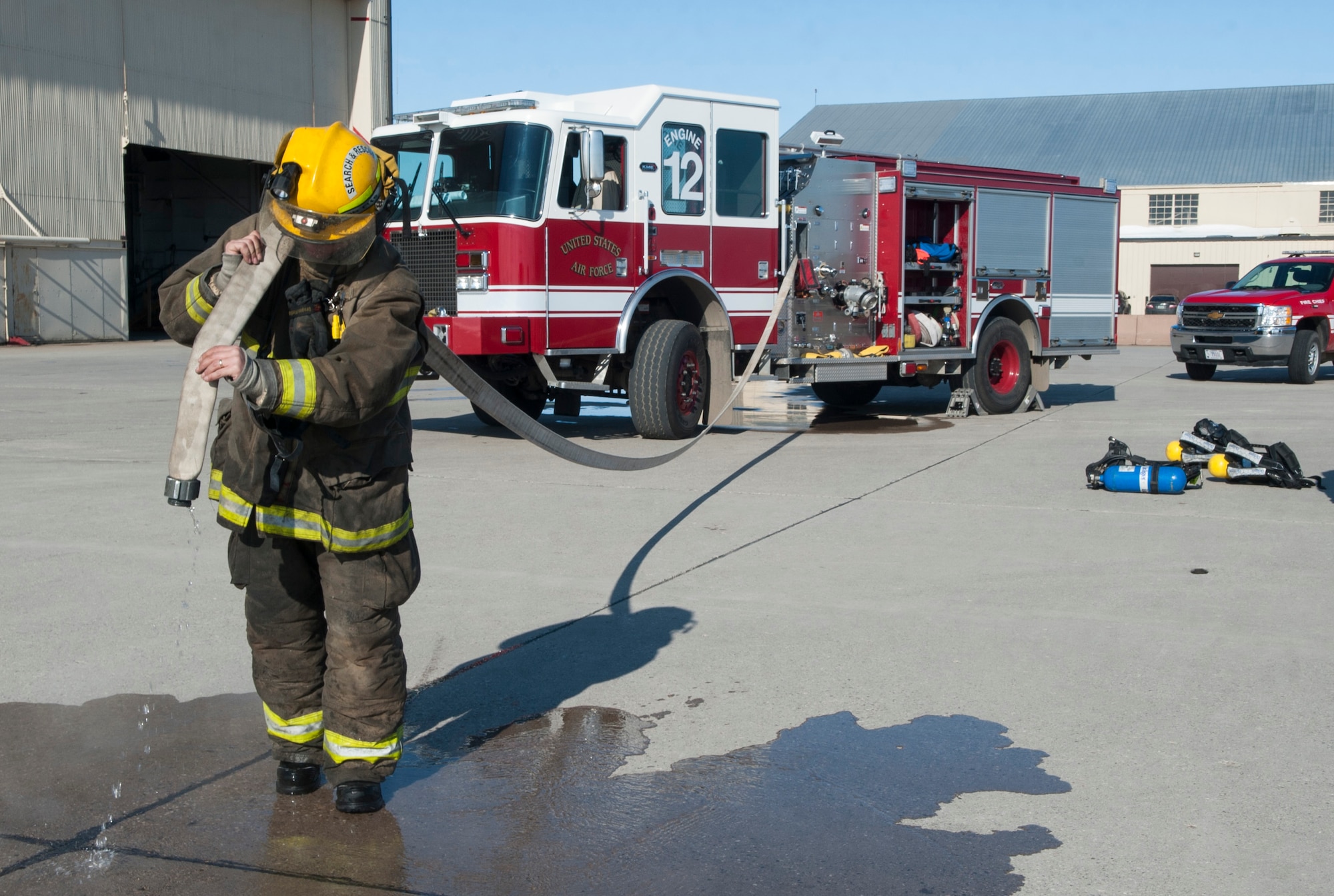 Tim McCartney, North Lemmon Fire Department firefighter, carries a fire hose at Minot Air Force Base, N.D., Feb. 24, 2017. The Minot AFB 5th Civil Engineer Squadron hosted a North Dakota Fire Association training class for mutual aid fire departments. (U.S. Air Force photo/Airman 1st Class Jonathan McElderry)