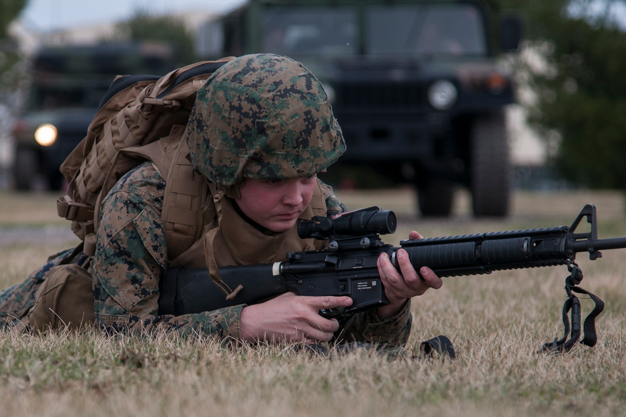 Lance Cpl. Bryant Bucci, Detachment 1, Communications Company, 4th Marine Logistics Group radio operator, keeps a lookout for danger during a simulated patrol at Grissom Air Reserve Base, Ind. on March 9, 2017. The patrol stopped at several checkpoints before setting up a mobile communications center. (U.S. Air Force photo/Staff Sgt. Dakota Bergl)