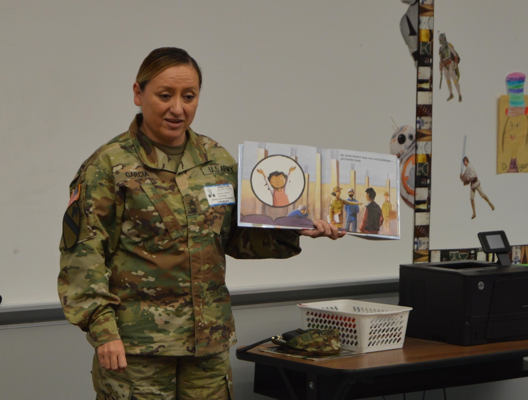 U.S. Army Reserve Master Sgt. Johnnie Garcia with the 4th Sustainment Command (Expeditionary) reads “Hero Mom” to students at Kinder Ranch Elementary in San Antonio, TX, Mar. 10, 2017. 