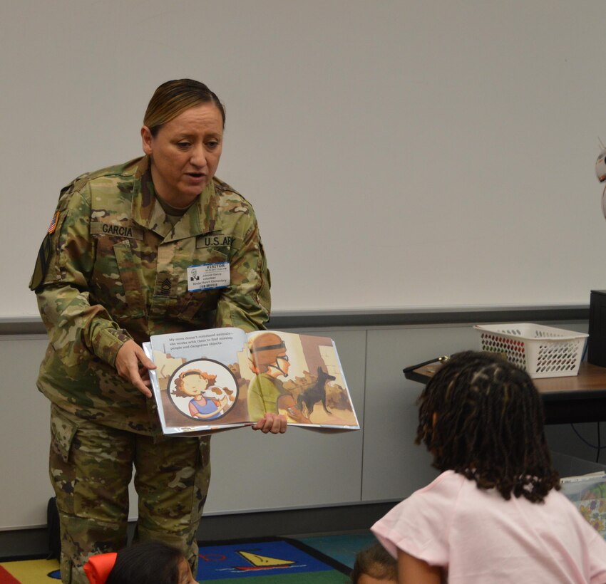 U.S. Army Reserve Master Sgt. Johnnie Garcia with the 4th Sustainment Command (Expeditionary) reads “Hero Mom” to students at Kinder Ranch Elementary in San Antonio, TX, Mar. 10, 2017. 
