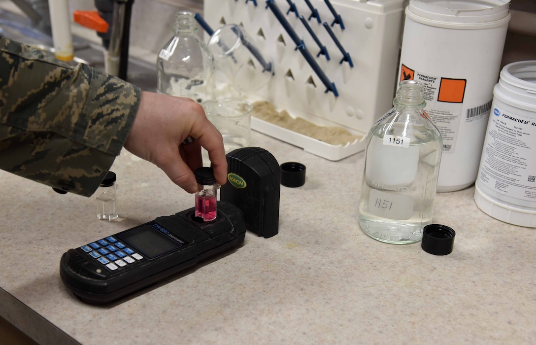 Staff Sgt. Shane Pentheny, 22nd Civil Engineer Squadron Water and Fuels System Maintenance technician, uses an analyzer to test water samples March 9, 2017, at McConnell Air Force Base, Kan. McConnell sampling results are consistently within state-required ranges. (U.S. Air Force photo/Airman 1st Class Erin McClellan)