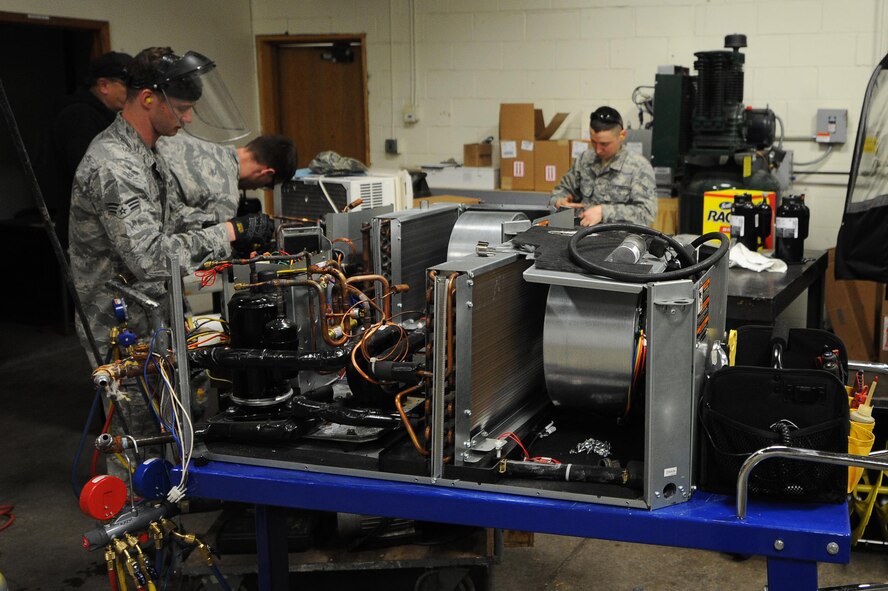5th Civil Engineer Squadron heating, ventilation, air conditioning and refrigeration technicians’ work on a heating and cooling unit at Minot Air Force Base, N.D., Feb. 28, 2017. The HVAC shop repairs units around base to help keep personnel cool during the summer and warm in the winter. (U.S. Air Force photo/Senior Airman Kristoffer Kaubisch)