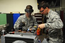 Senior Airman Tate Lawson and Senior Airman Michael Robinson, 5th Civil Engineer heating, ventilation, air conditioning and refrigeration technicians, solder valves onto a heating and cooling unit at Minot Air Force Base, N.D., Feb. 28, 2017. Climate control is important to help a comfortable work area to Airmen. (U.S. Air Force photo/Senior Airman Kristoffer Kaubisch)