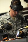 Senior Airman Tate Lawson, 5th Civil Engineer heating, ventilation, air conditioning and refrigeration technician, solders valves onto a compressor at Minot Air Force Base, N.D., Feb. 28, 2017. Climate control is important to help provide a comfortable work area to Airmen. (U.S. Air Force photo/Senior Airman Kristoffer Kaubisch)