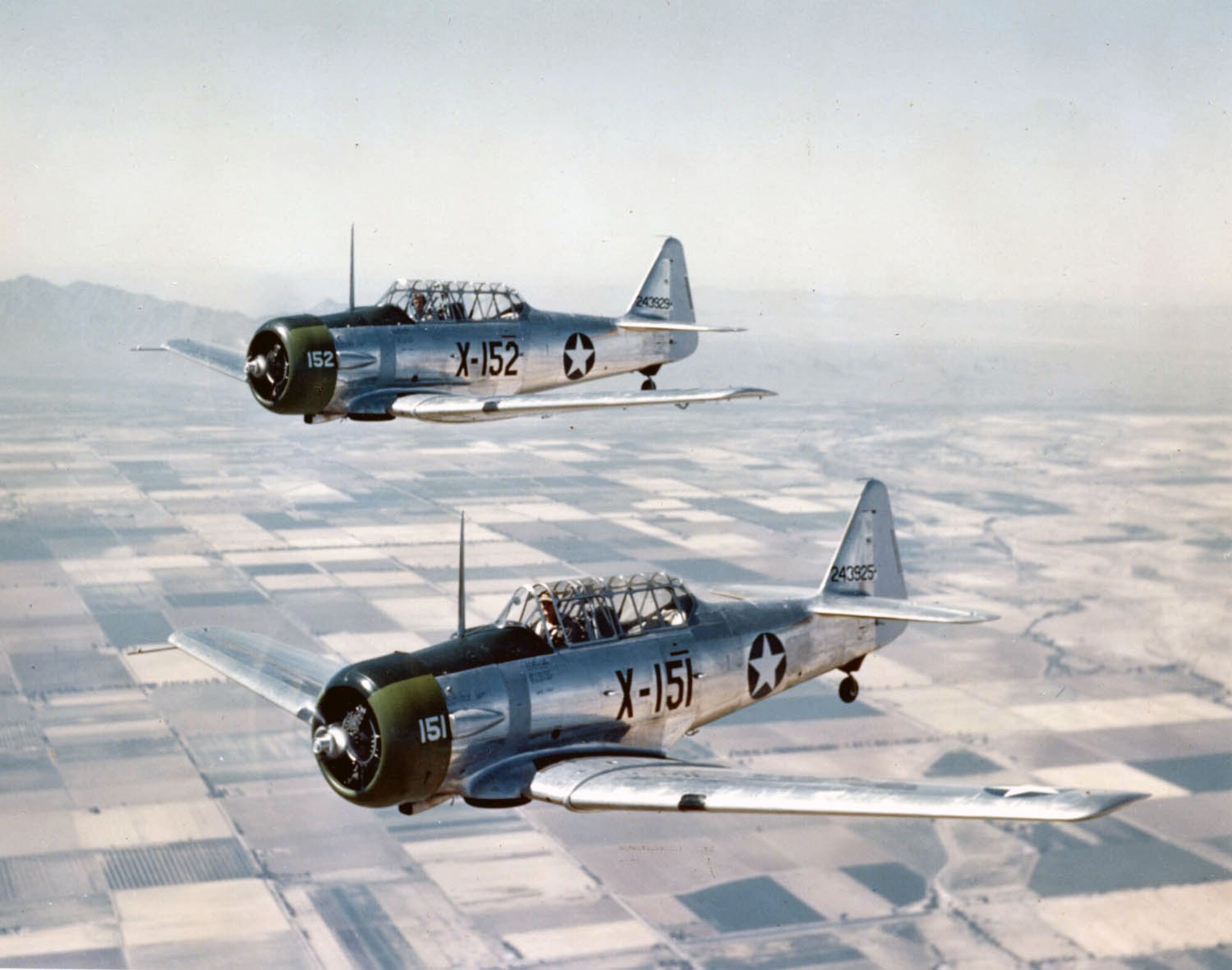 Two U.S. Air Force AT-6C’s fly near Luke Field in 1943. The AT-6’s were the first trainer aircraft flown by Luke in 1941. (Courtesy Photo)