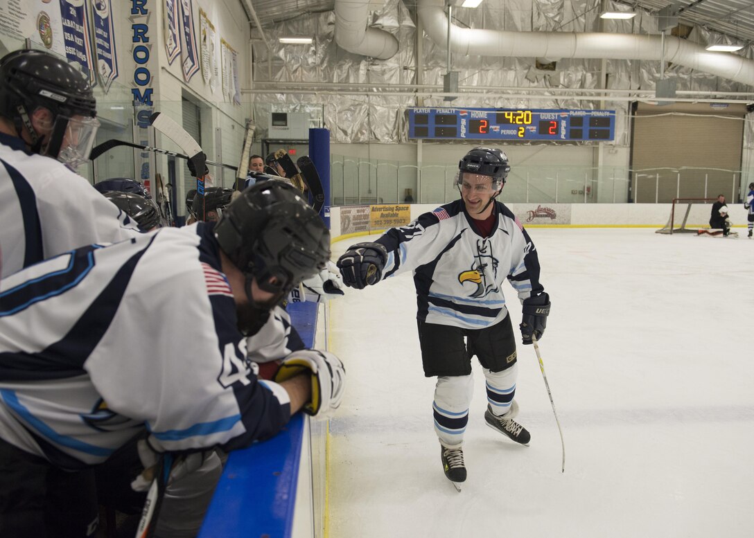 Bernard Pecoraro, Dover Eagles forward, fist-bumps teammates after scoring a goal during a charity hockey game March 11, 2017, at the Centre Ice Rink in Harrington, Del. Pecoraro works as a response force member with the 436th Security Forces Squadron. (U.S. Air Force photo by Senior Airman Zachary Cacicia)