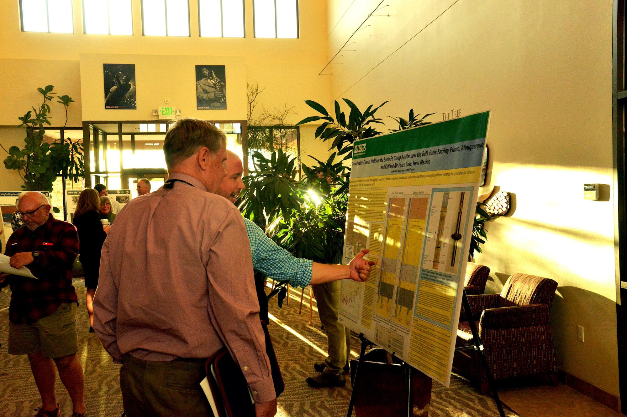 Rick Sheen, Albuquerque Water Utility Authority water quality hydrologist, shows a member of the public the data collection system for the Bulk Fuels Facility spill cleanup before a town hall in Albuquerque, New Mexico, March 9. The town hall featured a poster session before the briefing to give the public a closer look at the cleanup process. (U.S. Air Force Photo/Senior Airman Chandler Baker)