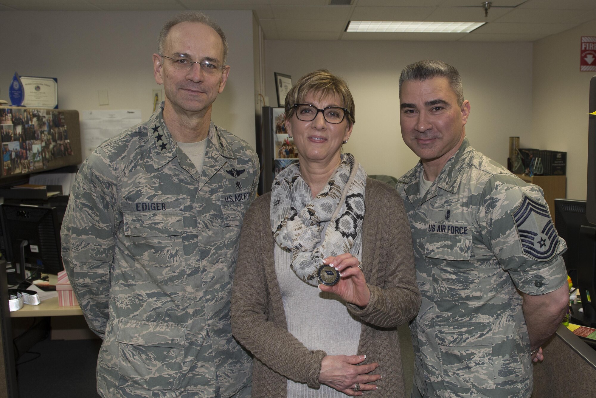 U.S. Air Force Lt. Gen. Mark Ediger, the Air Force surgeon general, Kathleen Lelevier, the 354th Medical Group bioenvironmental water program manager, and Chief Master Sgt. Edward Pace, the Medical Enlisted Forces chief, pose for a photo, March 10, 2017 at Eielson Air Force Base, Alaska. Ediger recognized Lelevier for her commitment to improving local water supplies. (U.S. Air Force photo by Airman Eric M. Fisher)