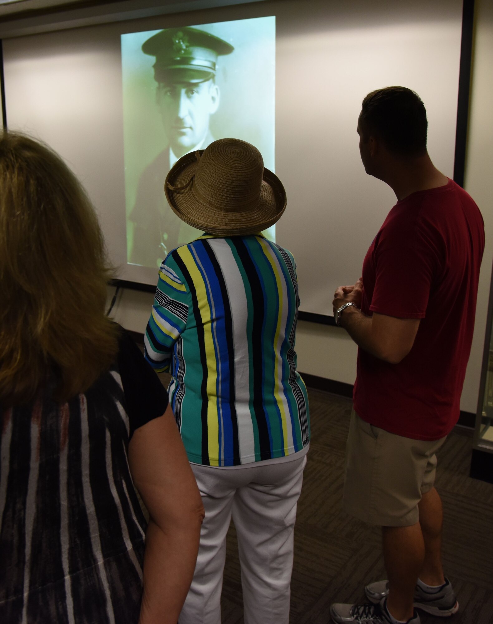 Jean Wolfe Zartman, daughter of Lt. Leroy Wolfe, watches a slide show with photos of her father and family at Wolfe Hall March 10, 2017, on Keesler Air Force Base, Miss. Zartman and her daughters received a tour of the facility and participated in a cake cutting ceremony at the building. Wolfe died in 1932 as the result of an airplane crash while assigned to the Philippines. (U.S. Air Force photo by Kemberly Groue)