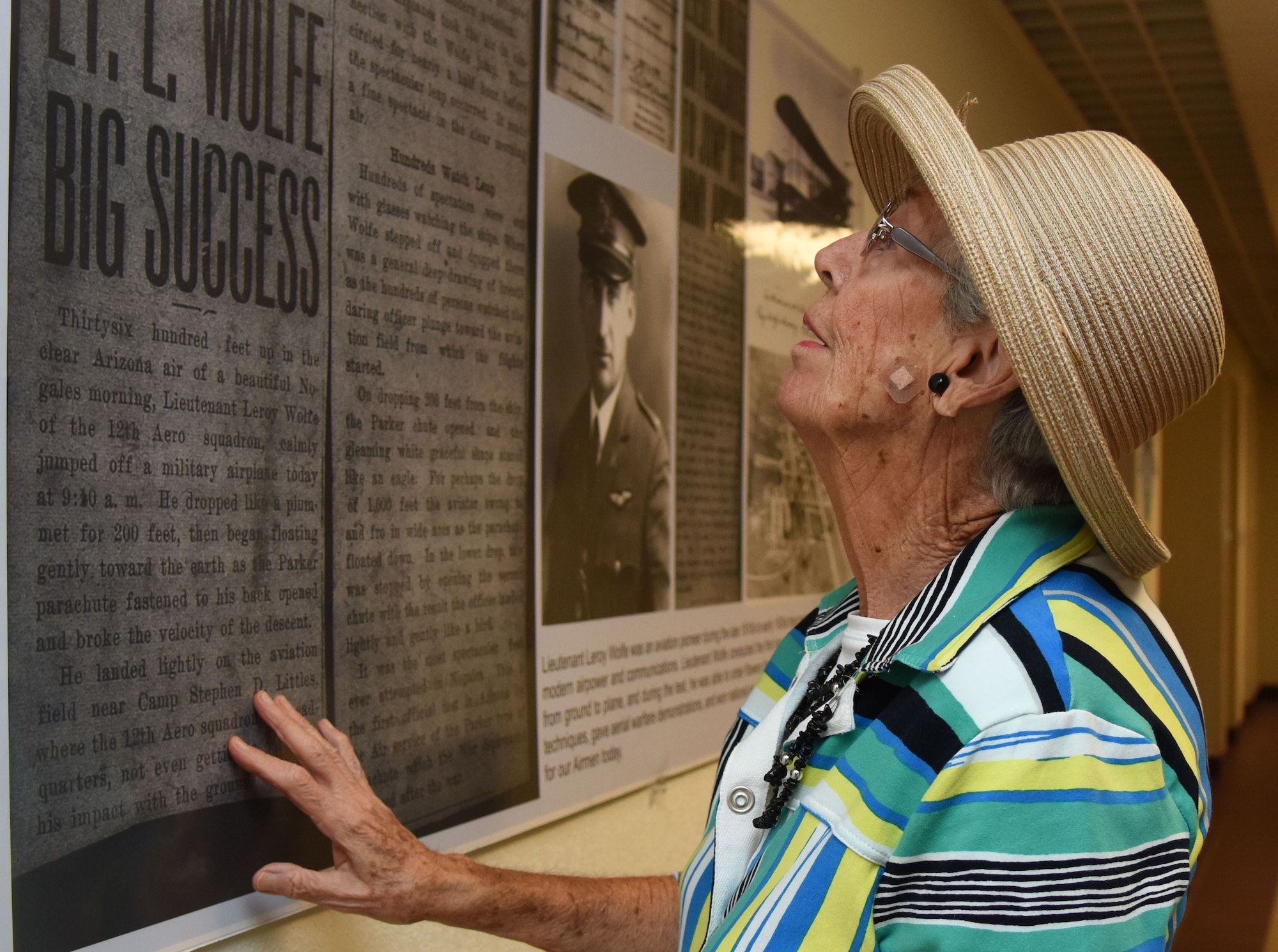 Jean Wolfe Zartman, daughter of Lt. Leroy Wolfe, views a wall display about her father at Wolfe Hall March 10, 2017, on Keesler Air Force Base, Miss. Zartman and her daughters received a tour of the facility and participated in a cake cutting ceremony at the building. Wolfe died in 1932 as the result of an airplane crash while assigned to the Philippines. (U.S. Air Force photo by Kemberly Groue)