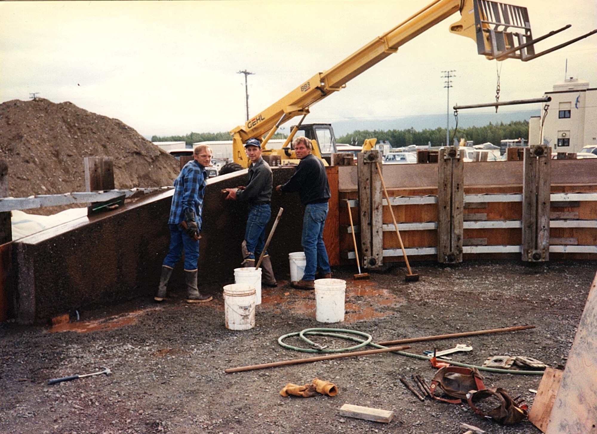 Kenneth and Donald Cutler, left to right, and Howard Goentzel work on the Yukla 27 memorial in the summer of 1996 at then-Elmendorf Air Force Base, Alaska (Courtesy Photo)