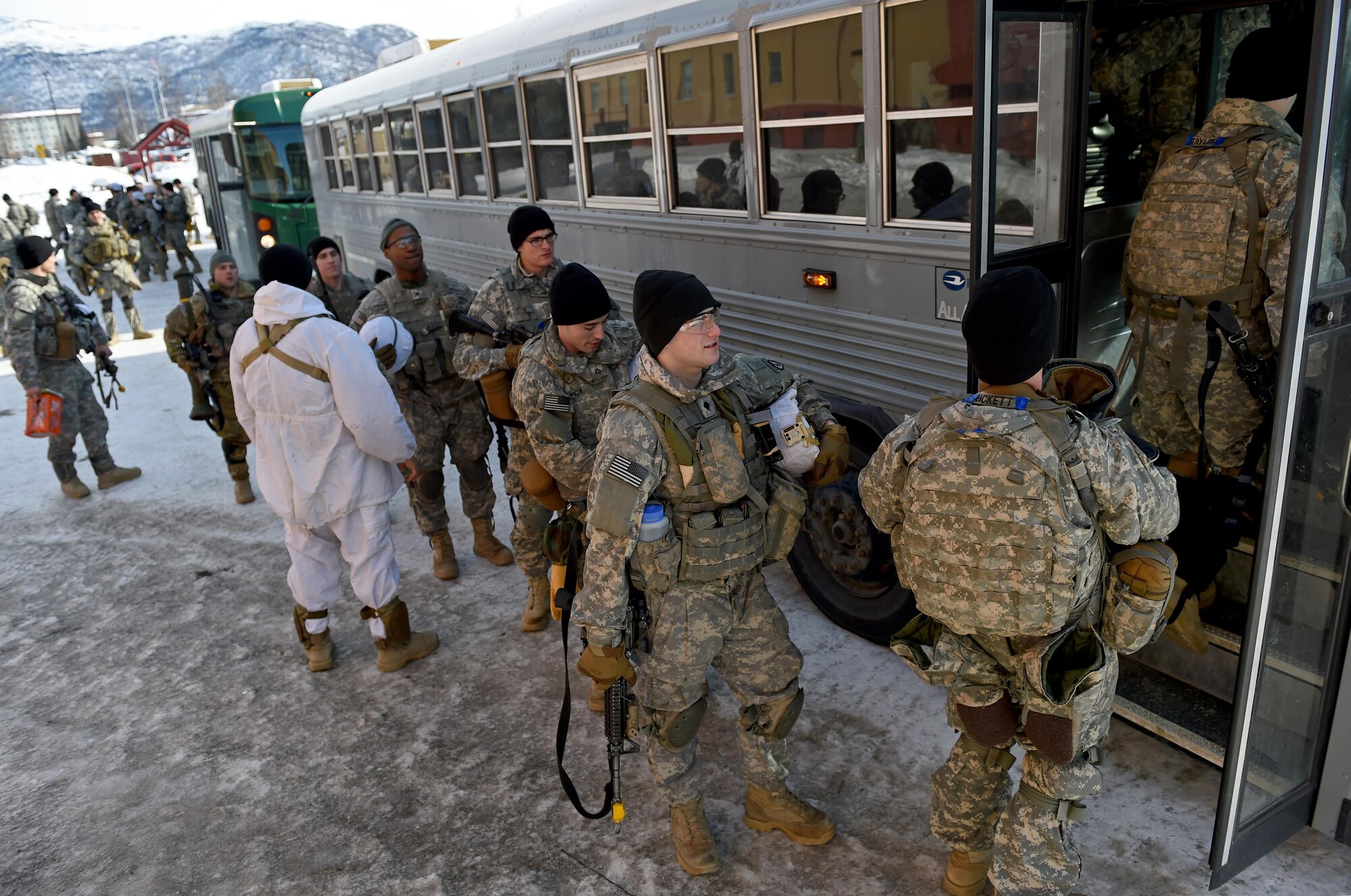 Soldiers of the 1st Battalion, 501st Parachute Infantry Regiment, 4th Infantry Brigade Combat Team (Airborne), 25th Infantry Division U.S. Army Alaska load onto a 44-passenger bus at Joint Base Elmendorf-Richardson, Alaska, March 13, 2017. At JBER, roughly 80 percent of the 773d Logistics Readiness Squadron vehicle operator support is to the Army.