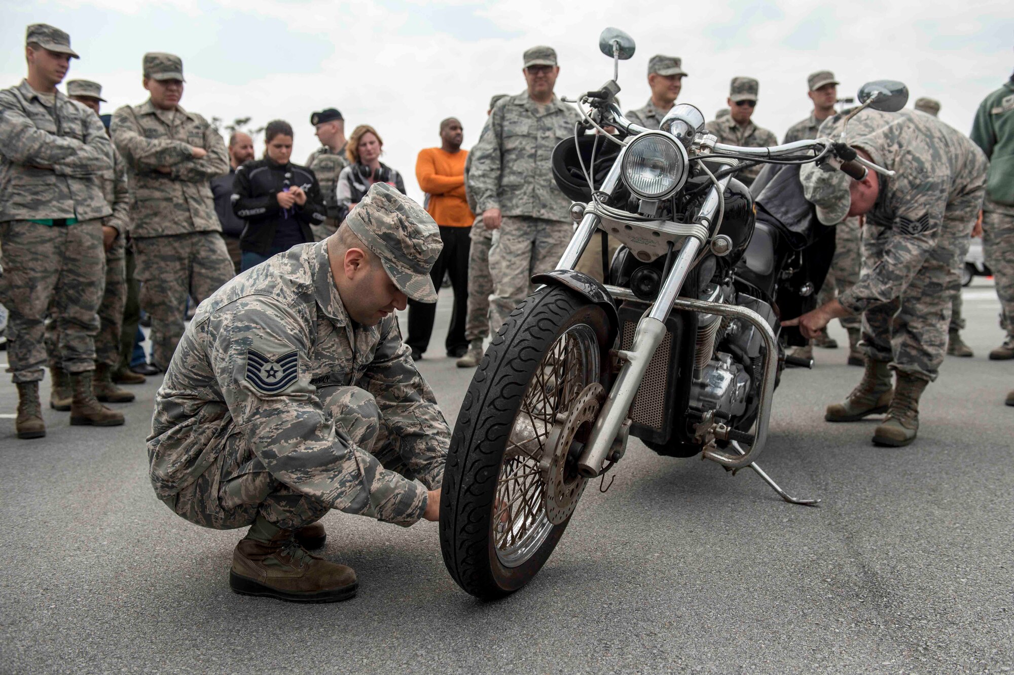 U.S. Air Force Tech. Sgt. Victor Estupinan, motorcycle rider, performs a pre-ride inspection checklist on his bike during an 18th Wing annual motorcycle safety brief March 9, 2017, at Kadena Air Base, Japan. Wing Safety and the Green Knights chapter 138 hosted the event to reinforce safety requirements and to promote mentorship opportunities for riders. (U.S. Air Force photo by Staff Sgt. Peter Reft/Released)